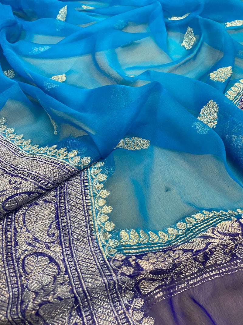 Shades of Benares presents a timeless elegance in the form of a classic blue pure Khaddi Chiffon handloom Banarasi saree.