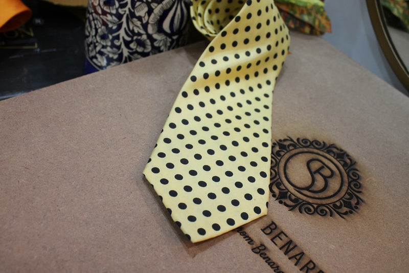 Stylish yellow tie with black dots, made of pure Banarasi satin silk. Perfect for adding a touch of elegance to any outfit.