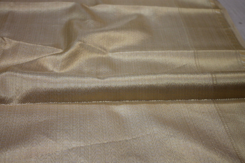 Opulent Banarasi Tissue Silk Saree in Creme with Gold & Silver Stripes by Shades of Benares.