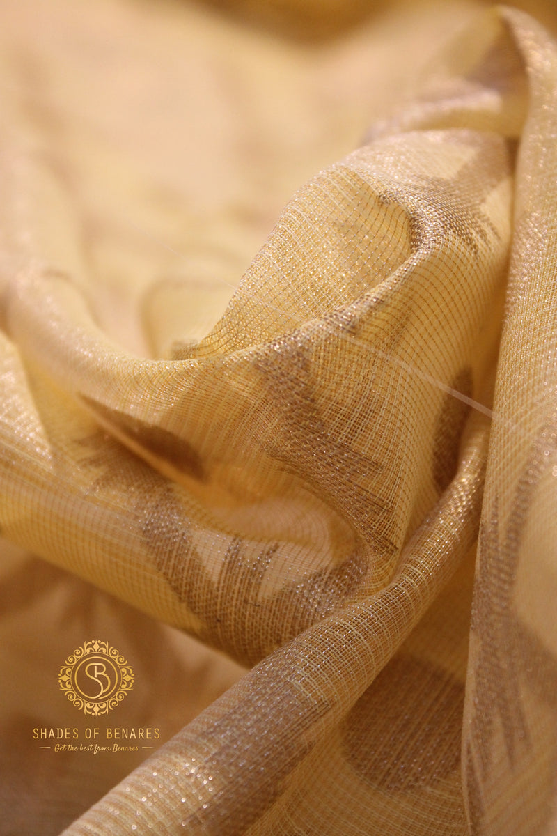 Radiant yellow tissue silk saree by Shades of Benares. A vibrant and elegant attire for any occasion.