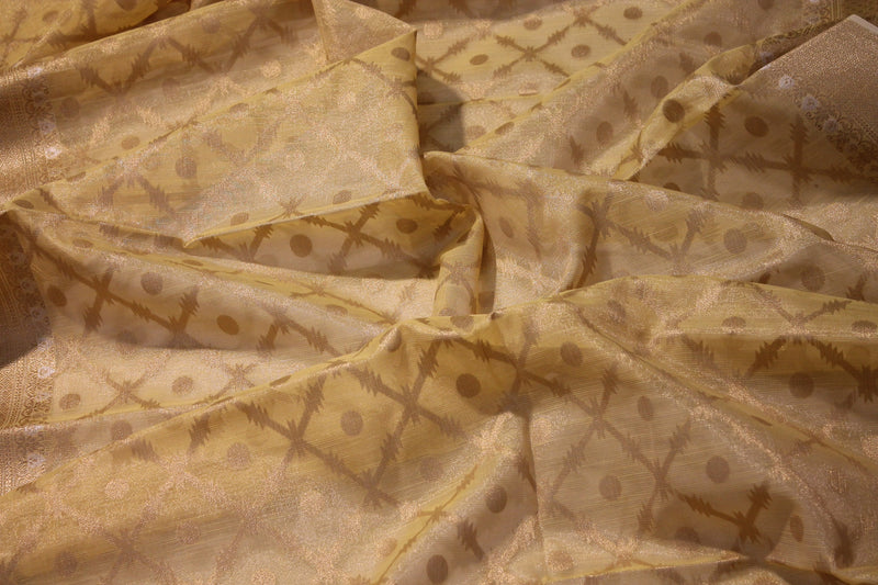 Radiant yellow tissue silk saree from Shades of Benares, exquisitely crafted.