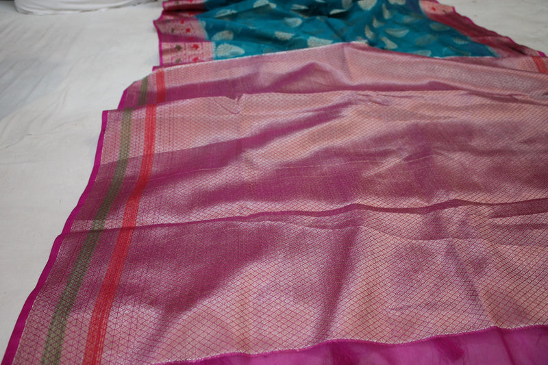  Elegant handwoven Banarasi Saree in seablue with pink border.