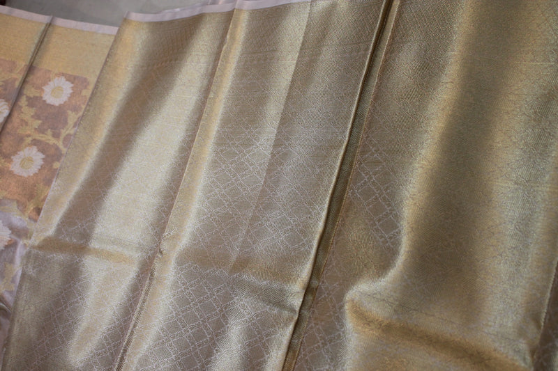 Charm exudes from this limited edition pastel pink pure tissue silk saree by Shades of Benares.