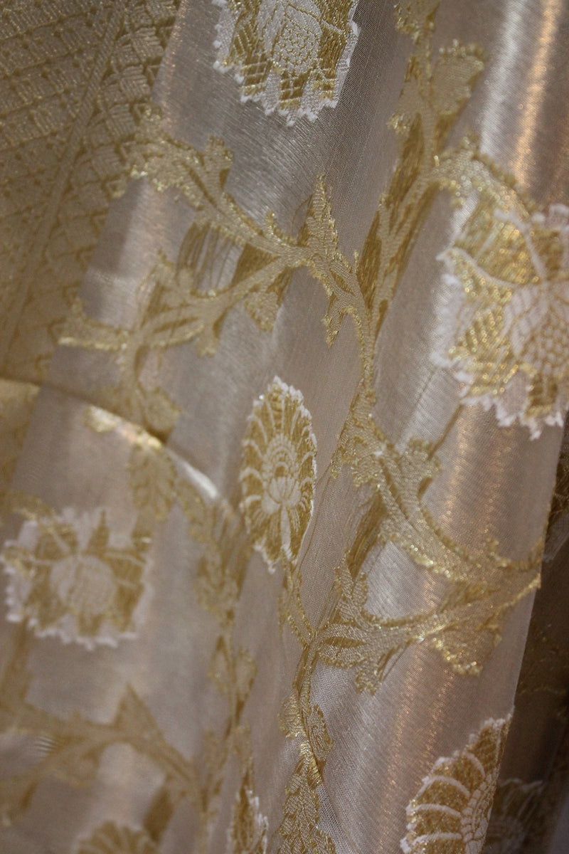  Explore the sophistication of shades of benares' Limited Edition Beige Pure Tissue Silk Saree.