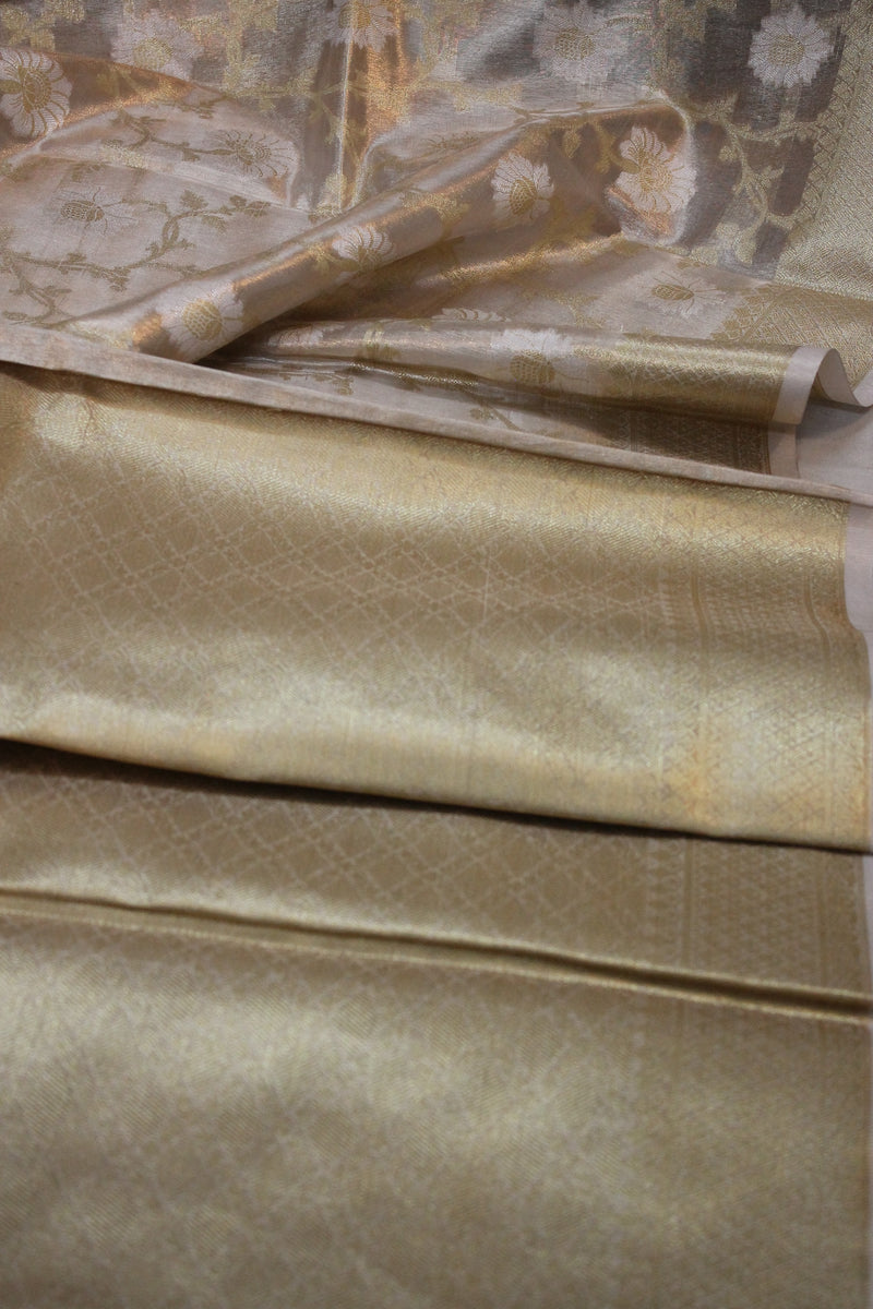 Elegant beige tissue silk saree by Shades of Benares. Limited edition piece showcasing sophistication.