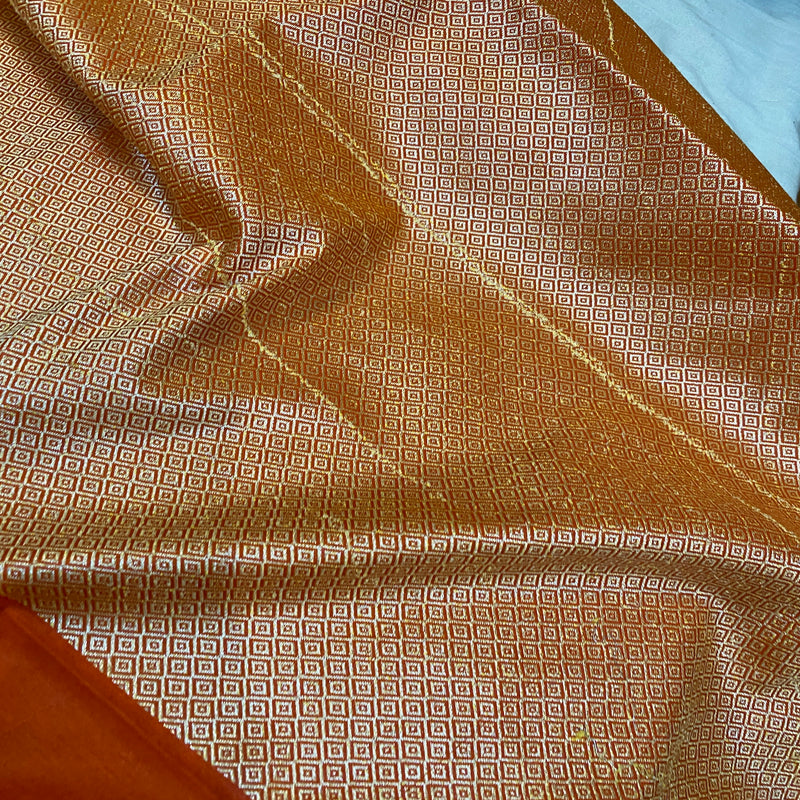Elevate your style with this versatile rust orange handloom crepe Banarasi silk sari. Ideal for formal gatherings and cultural occasions.