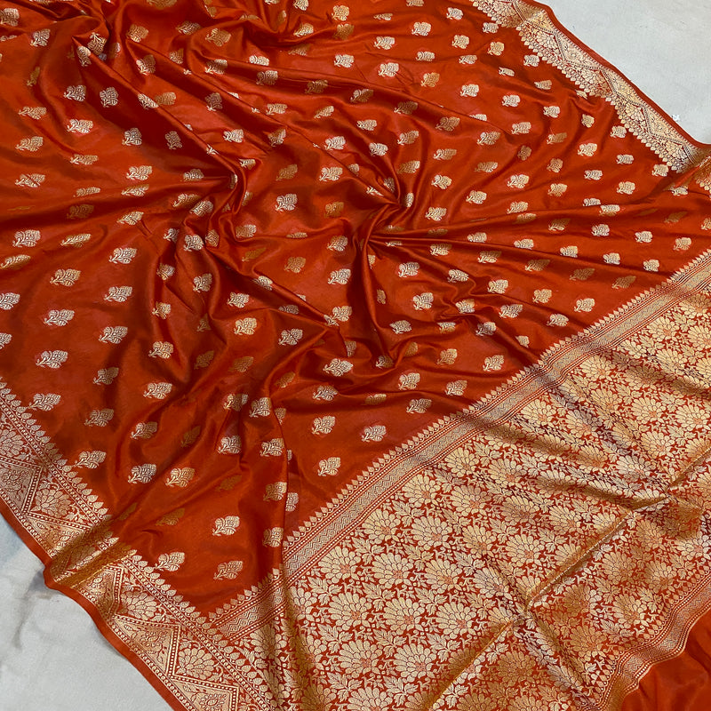 Rust orange handloom crepe Banarasi silk sari for a sophisticated and elegant look. Perfect for formal events and cultural celebrations.