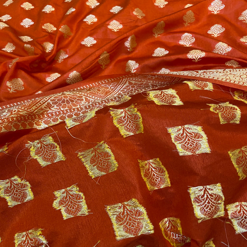 Shop now for a sophisticated rust orange handloom crepe Banarasi silk sari, perfect for formal gatherings and cultural celebrations.