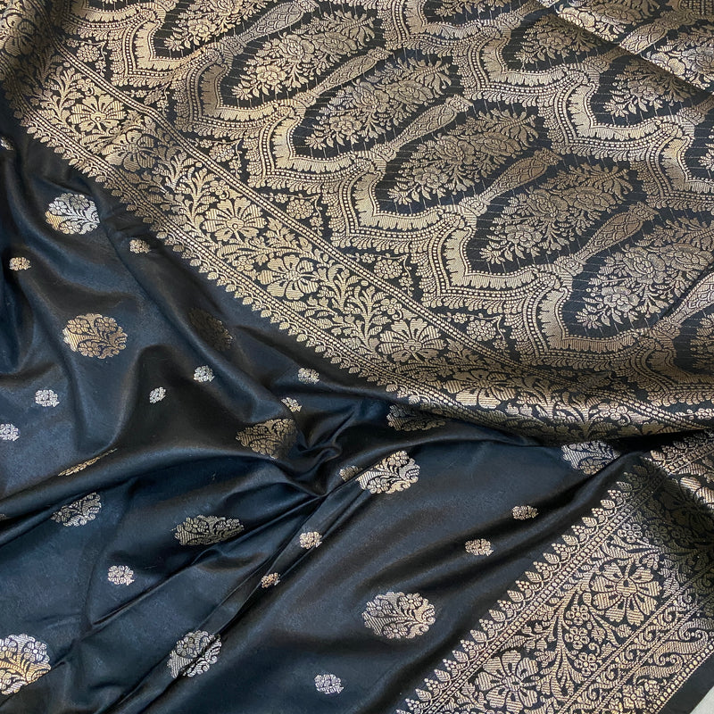 Make a bold statement with our black handloom crepe Banarasi silk saree. Perfect for formal events, exuding confidence.