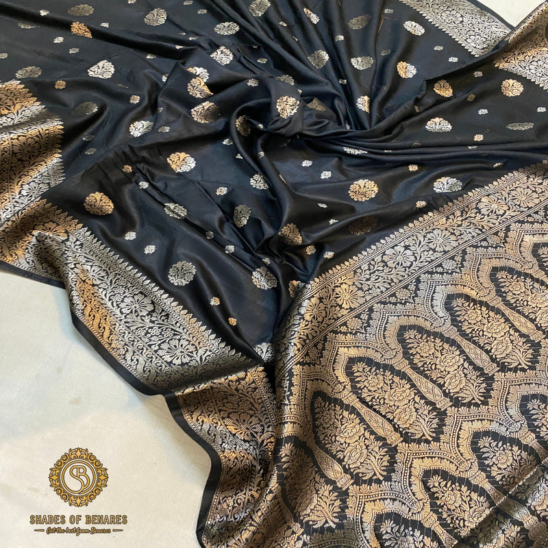 Black handloom crepe Banarasi silk saree, perfect for formal events. Exudes confidence and artisanal craftsmanship.