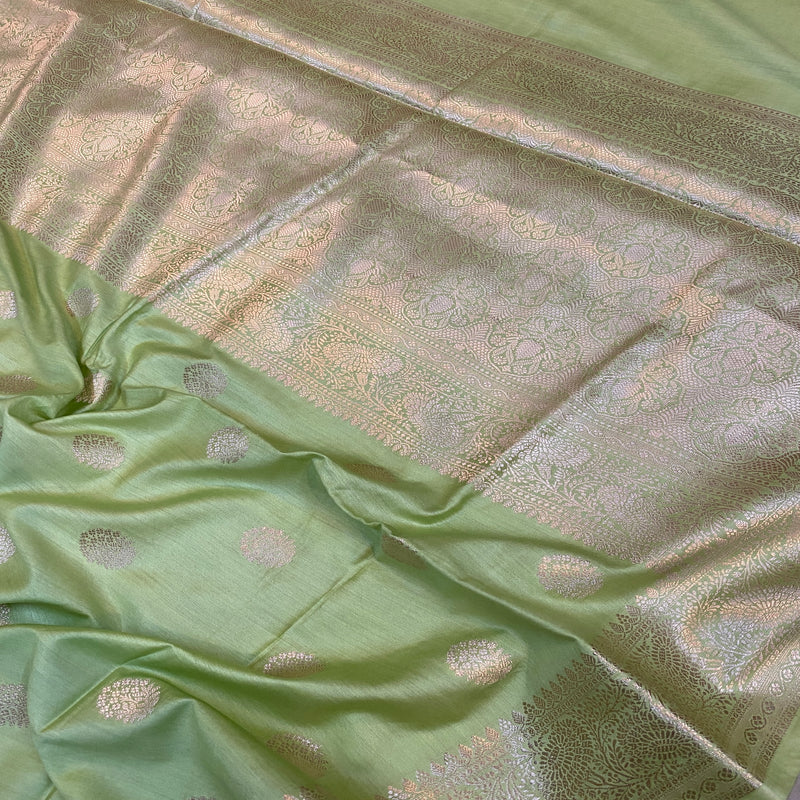 Elegant pastel green handloom crepe Banarasi silk sari, handcrafted with artisanal precision and delicate motifs.