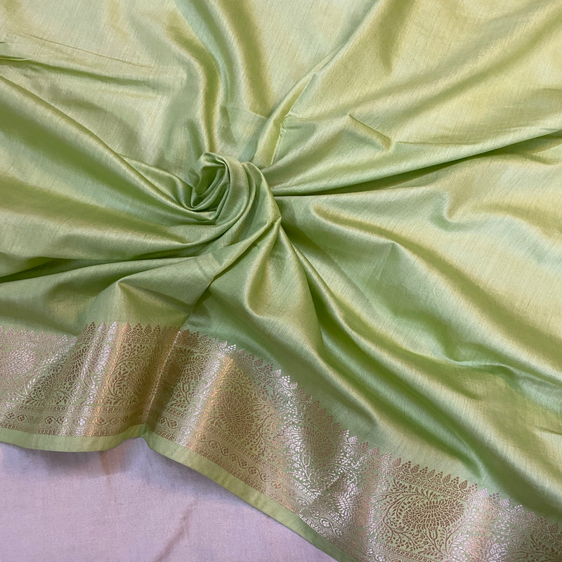 Sophisticated pastel green handloom crepe Banarasi silk sari, perfect for daytime events or formal gatherings.