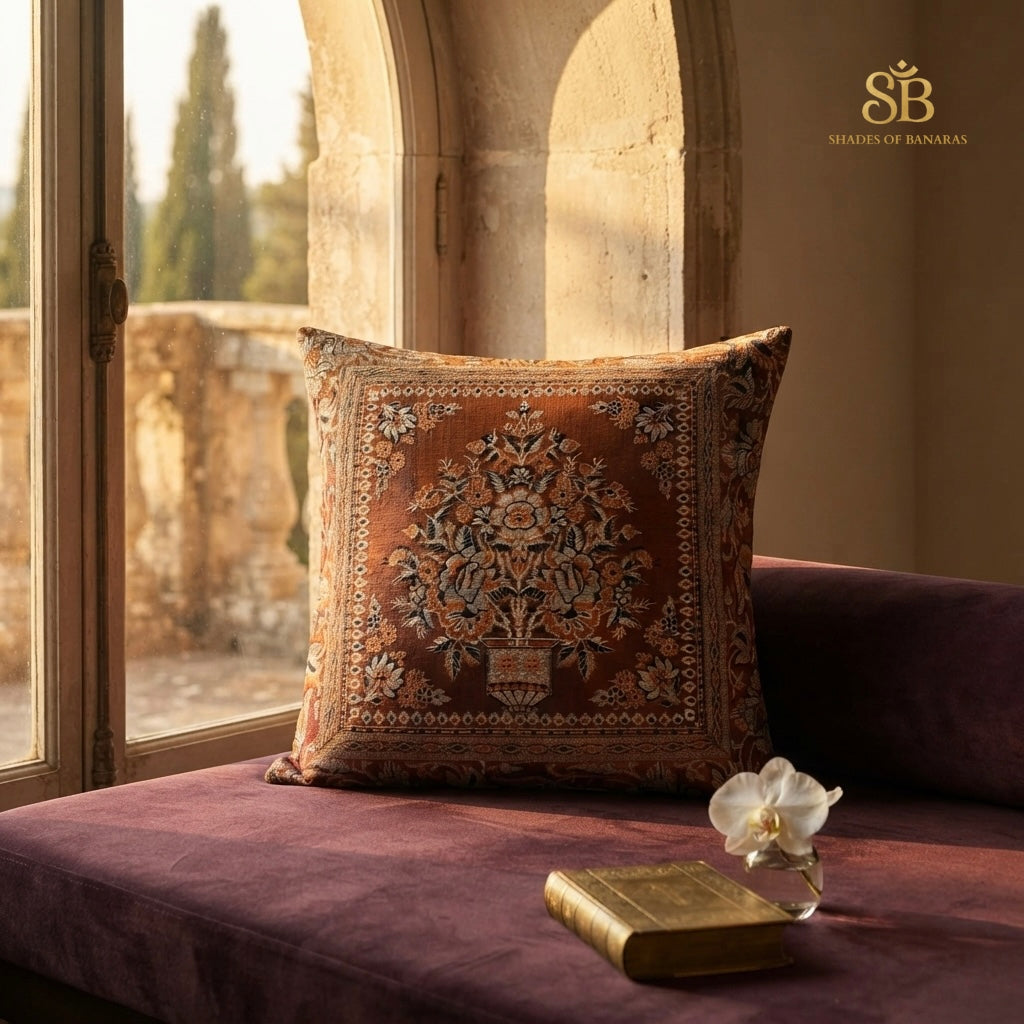 Orange pure brocade Banarasi handloom cushion cover with floral vase motif on a plum velvet window seat
