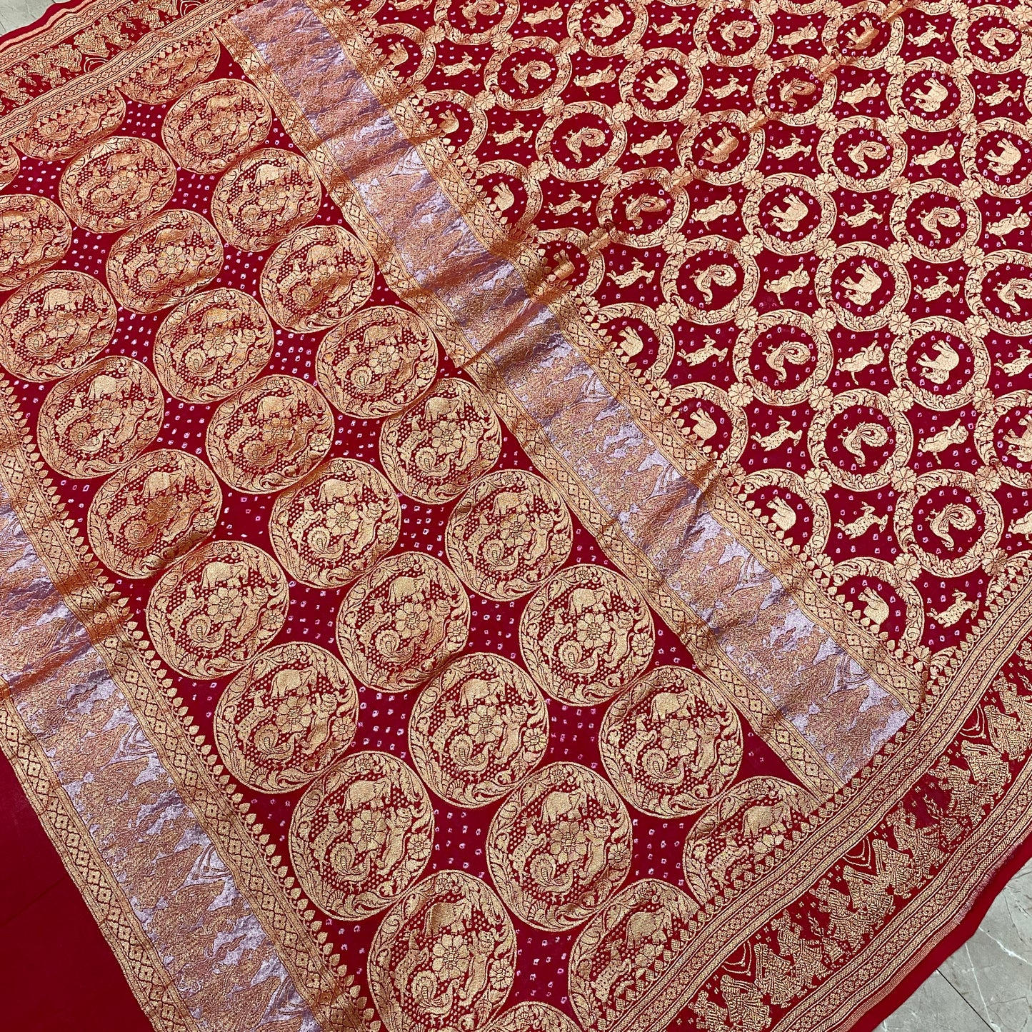 Crimson Heritage: Red Khaddi Georgette Bandhani Saree with Shikargaah Weave The quintessential hue of love, reimagined in the lightest of silks. by Shades Of Banaras - banarasi - banarasi saree shop - banarasi saree manufacturers - banarasi saree wholesale - banaraasi sarees