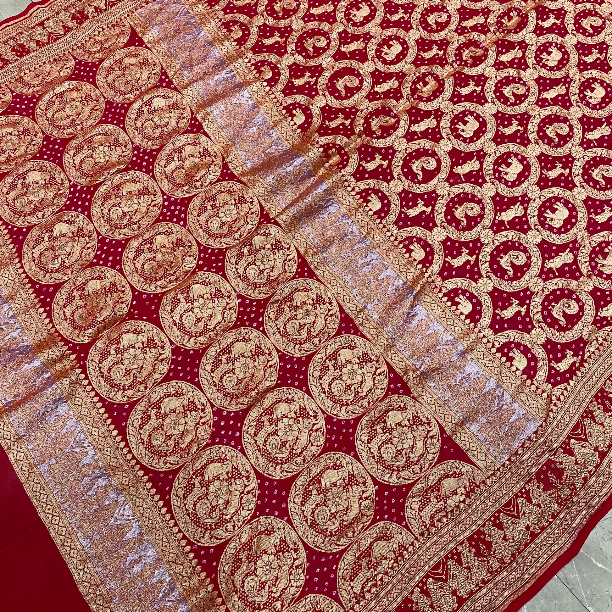 Crimson Heritage: Red Khaddi Georgette Bandhani Saree with Shikargaah Weave The quintessential hue of love, reimagined in the lightest of silks. by Shades Of Banaras - banarasi - banarasi saree shop - banarasi saree manufacturers - banarasi saree wholesale - banaraasi sarees