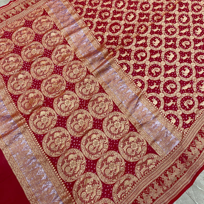 Crimson Heritage: Red Khaddi Georgette Bandhani Saree with Shikargaah Weave The quintessential hue of love, reimagined in the lightest of silks. by Shades Of Banaras - banarasi - banarasi saree shop - banarasi saree manufacturers - banarasi saree wholesale - banaraasi sarees
