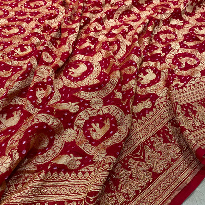 Crimson Heritage: Red Khaddi Georgette Bandhani Saree with Shikargaah Weave The quintessential hue of love, reimagined in the lightest of silks. by Shades Of Banaras - banarasi - banarasi saree shop - banarasi saree manufacturers - banarasi saree wholesale - banaraasi sarees