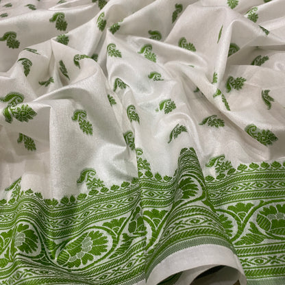 The Verdant Heirloom: Luxe Hand-Embroidered White & Green Pure Cotton Banarasi Sari by Shades Of Banaras - banarasi - banarasi saree shop - banarasi saree manufacturers - banarasi saree wholesale - banaraasi sarees - banarasi sari - banarasi saris - silk saree - silk sari - wedding saree - wedding sari - designer sari - wedding collection - gifting