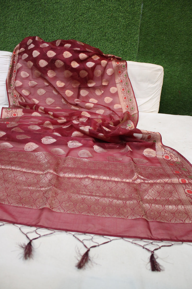 A luxurious Maroon Kora Organza Banarasi Saree by Shades of Benares, featuring intricate handloom work.