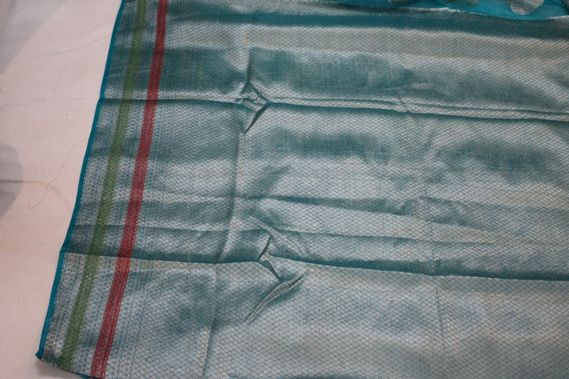 Captivating blue Banarasi saree made of handloom Kora Organza fabric; a creation by Shades of Benares.
