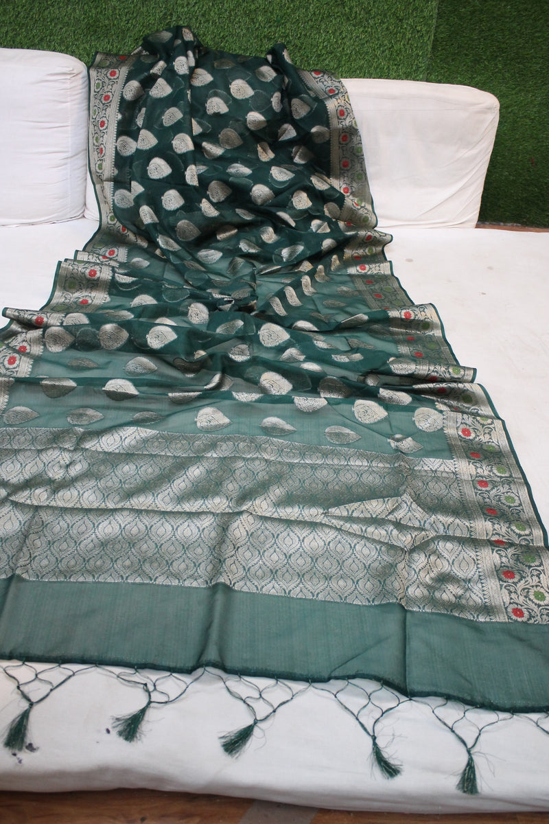 Enchanting Bottle Green Kora Organza Handloom Banarasi Saree by shades of benares: A mesmerizing green handloom saree made of Kora Organza material by shades of benares.