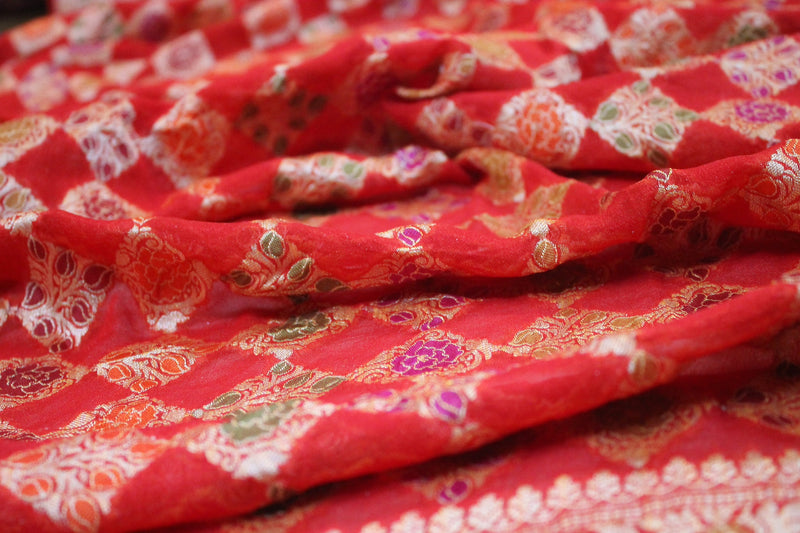 Vibrant red Banarasi saree in pure Khaddi Georgette by Shades of Benares, exuding timeless beauty.