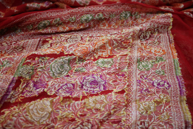 A vibrant red pure khaddi georgette Banarasi saree by Shades of Benares, radiating elegance.