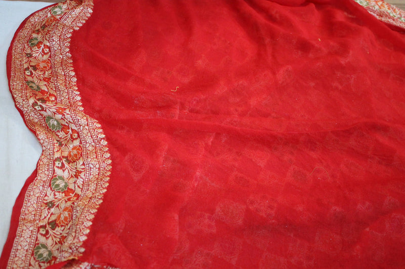 Stunning Radiant Red Banarasi Saree made of pure Khaddi Georgette by Shades of Benares, a symbol of grace.