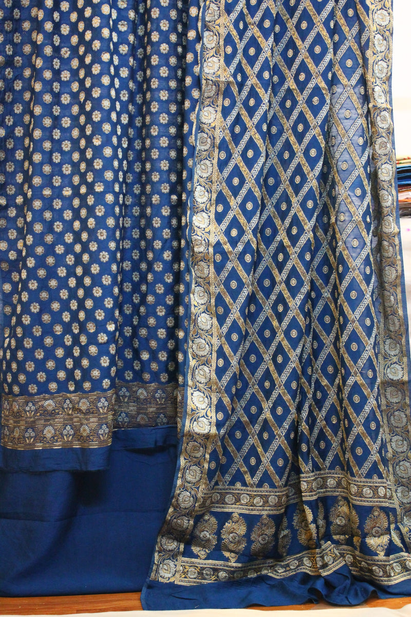 Serenade in Blue: Handloom 3-Piece Cotton Silk Banarasi Suit Set by shades of benares. A stunning blue suit set with intricate handloom work.