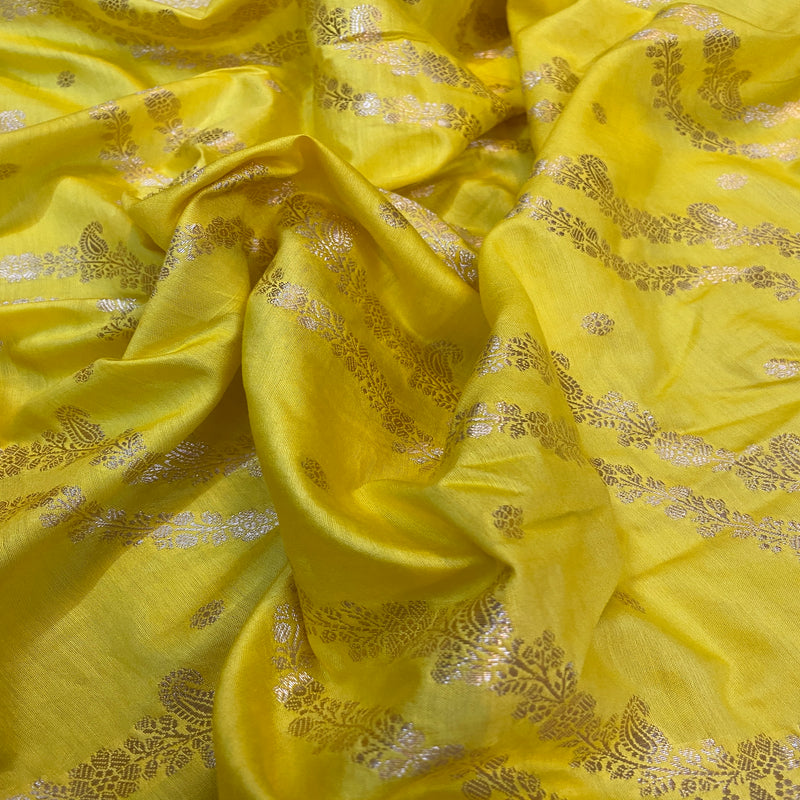 Elegant bright yellow Crepe Silk Handloom Saree exuding luxury and sophistication.