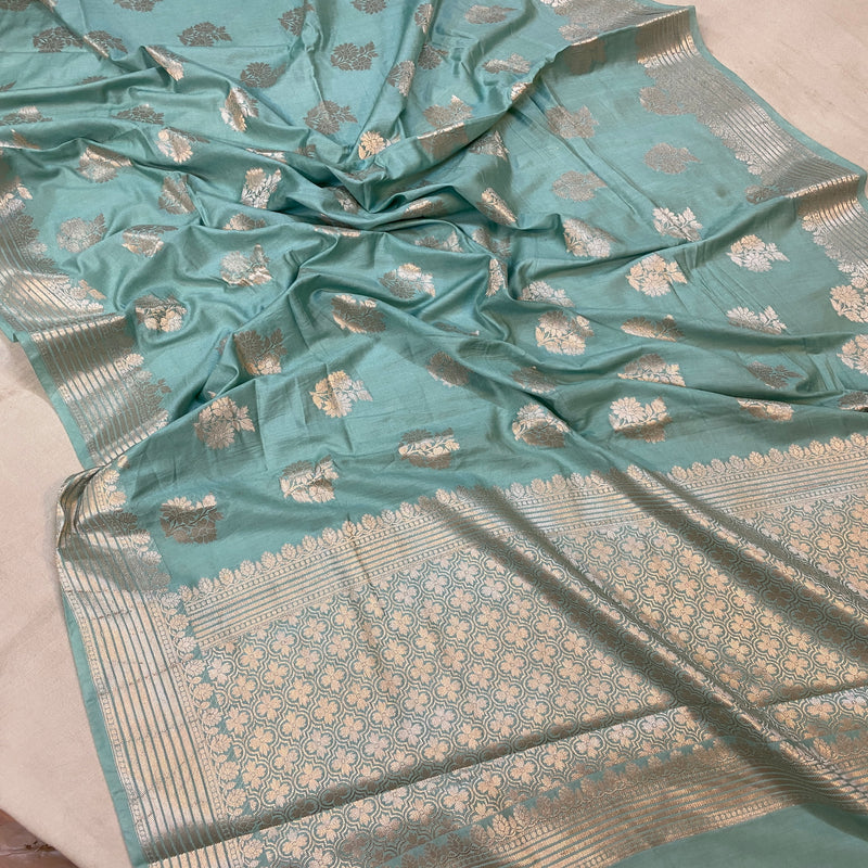 Make a statement at your next party with our serene sea blue handloom Banarasi silk saree. Perfect for special occasions, exuding timeless elegance.