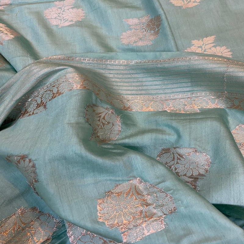 Make a statement at your next party with our serene sea blue handloom Banarasi silk saree. Exuding timeless elegance, it's perfect for special occasions