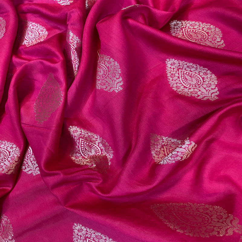 Elevate your style with a hot pink handloom Banarasi silk sari, perfect for weddings and special events. Vibrant elegance and traditional craftsmanship.