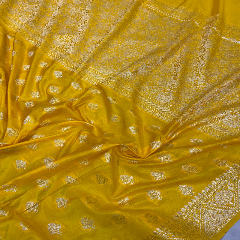 Festive yellow handloom crepe Banarasi silk sari, exuding joyous elegance and artisanal celebration. Elevate your festive look with this versatile piece!