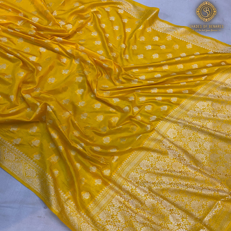 Festive yellow handloom crepe Banarasi silk sari, perfect for traditional ceremonies and cultural events. Elevate your festive look with this versatile piece!