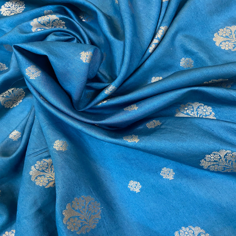 Elevate your style with our matte blue handloom crepe Banarasi silk saree. Perfect for formal events and festive celebrations, showcasing understated elegance and artisanal craftsmanship.