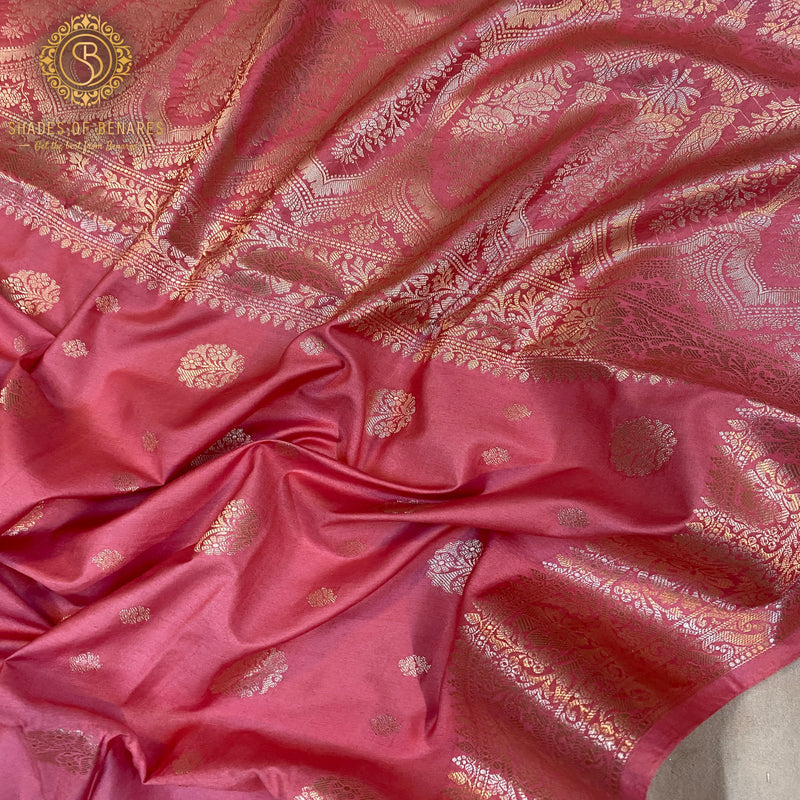 Luxurious pink handloom crepe Banarasi silk saree with intricate patterns and vibrant pink hue. Perfect for weddings and festivals. Made from 100% silk, it will make you feel like royalty.