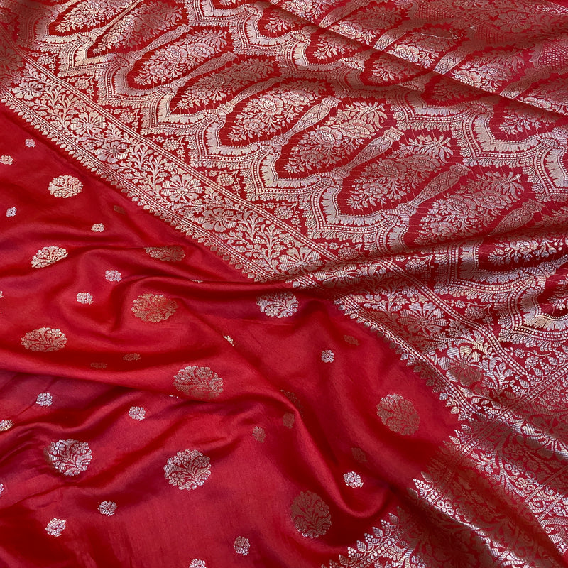 Elegant red handloom crepe Banarasi silk sari with intricate weaving and luxurious silk fabric. Ideal for weddings, cultural events, or festive celebrations.