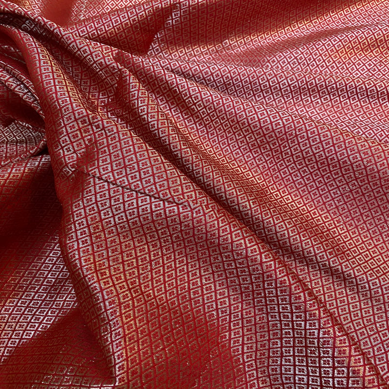 Elegant red handloom crepe Banarasi silk sari with intricate weaving and luxurious silk fabric, perfect for weddings or cultural events.