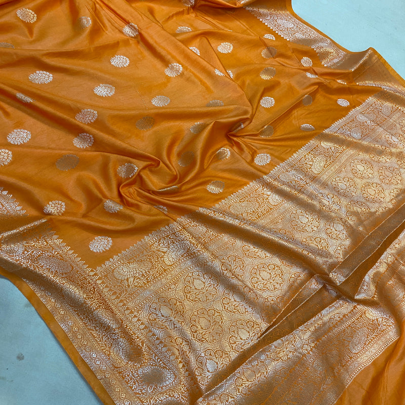 Luxurious silk fabric in a vibrant orange hue. Traditional artistry meets modern elegance in this Banarasi silk sari.