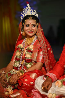  A beautiful bride dressed in a traditional red Banarasi silk saree.