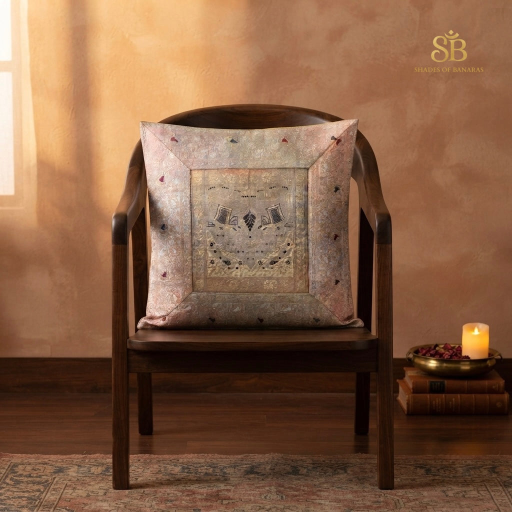Pink brocade Banarasi cushion cover with framed zari panel on a wooden chair