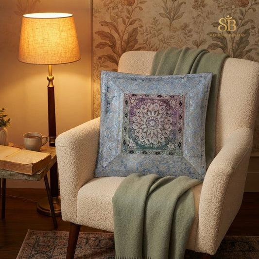 Blue brocade Banarasi cushion cover with mandala medallion on a cream armchair
