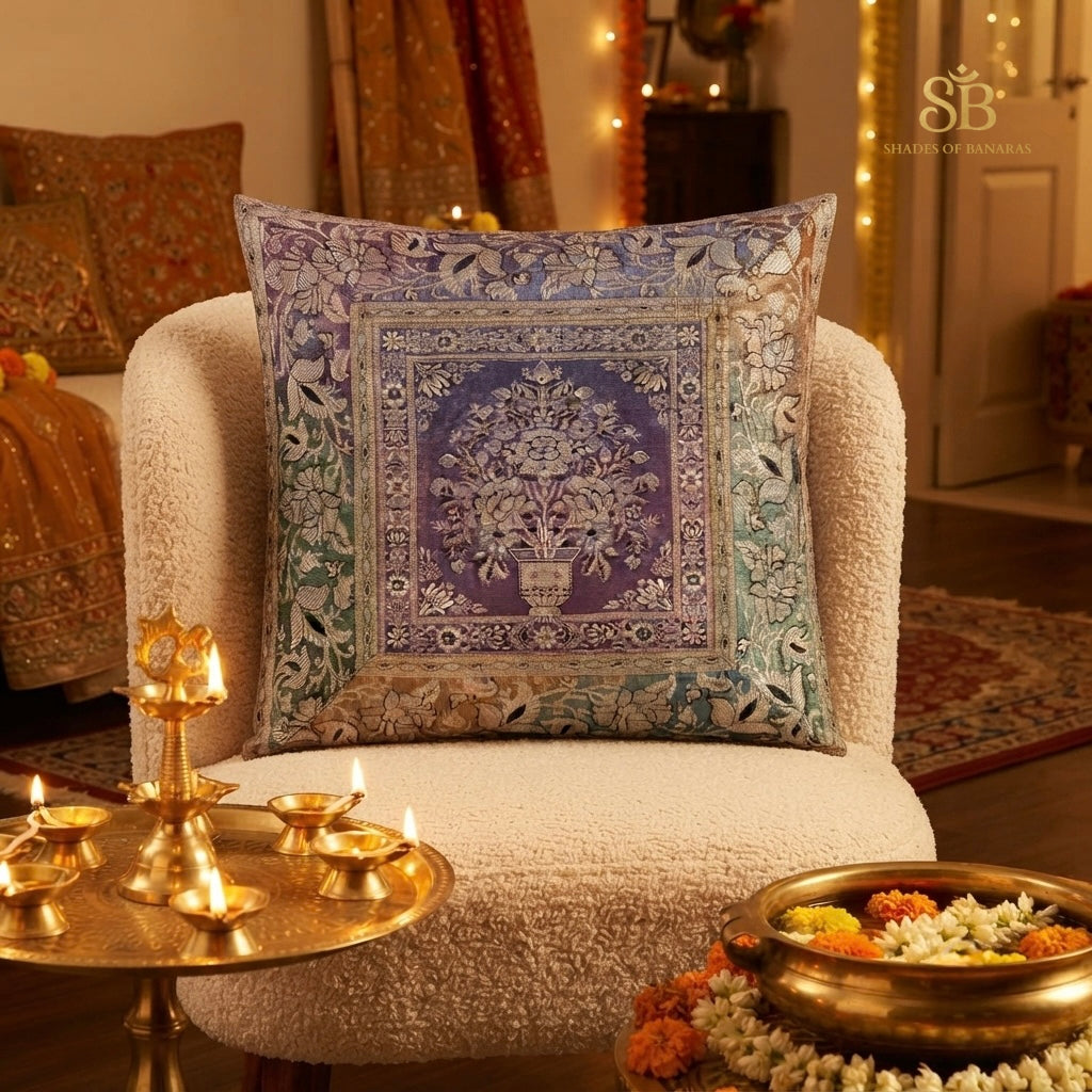 Multicolor brocade Banarasi cushion cover with flowering tree motif beside festive diyas