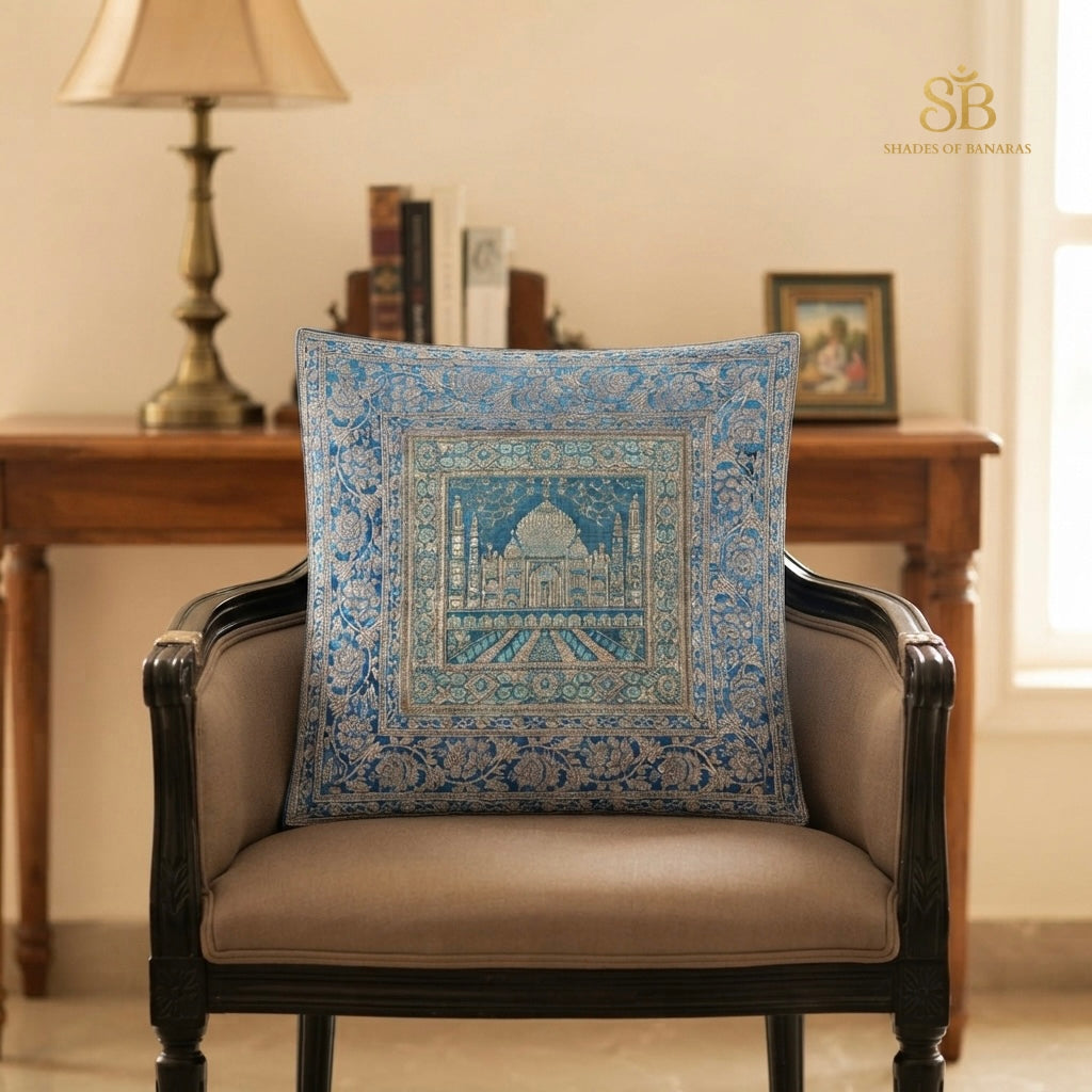 Blue brocade Banarasi cushion cover with silver Taj Mahal motif on a carved armchair