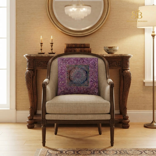 Purple brocade Banarasi cushion cover with mandala medallion on a linen armchair