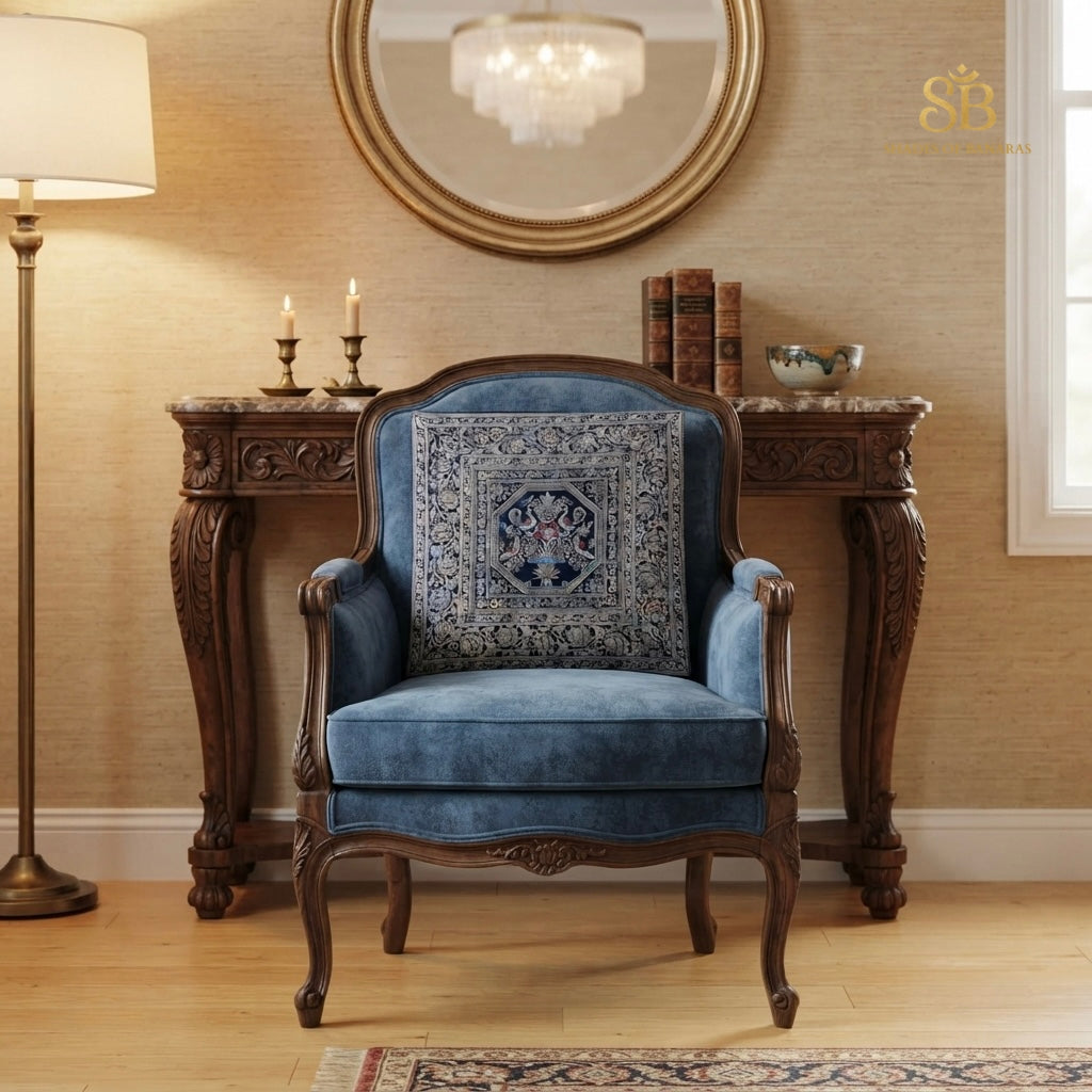 Blue brocade Banarasi cushion cover with octagon bird medallion on a carved blue velvet chair