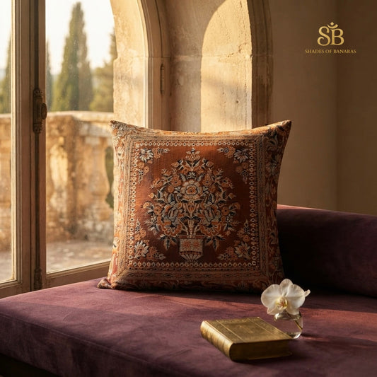 Orange pure brocade Banarasi handloom cushion cover with floral vase motif on a plum velvet window seat