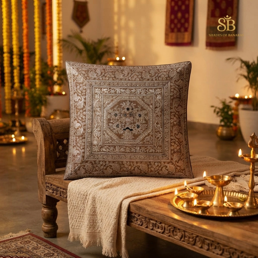Light brown pure brocade Banarasi handloom cushion cover with octagon medallion on a carved wooden bench