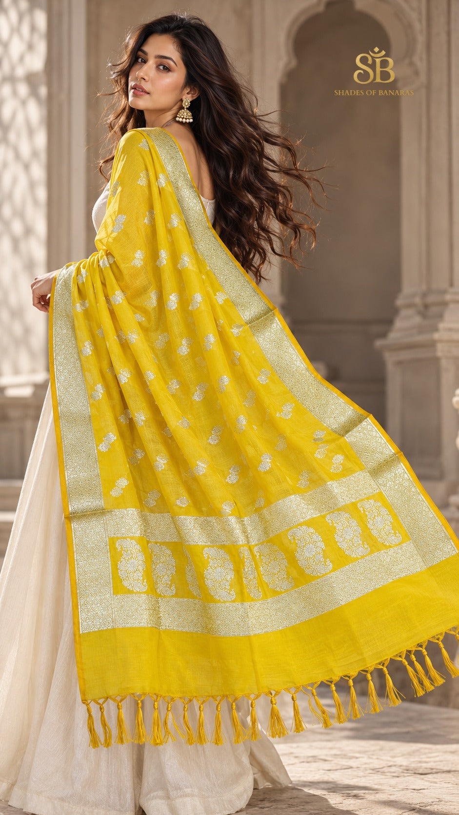 Sunlit marigold yellow katan soft silk Banarasi handloom dupatta with cutwork butis from Banaras, draped over a cream suit